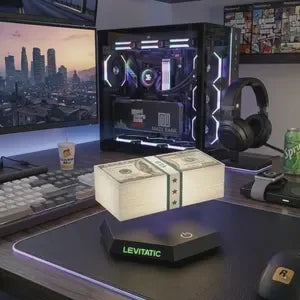 Levitating money stack on LED base, modern desk setup with RGB PC and gaming gear